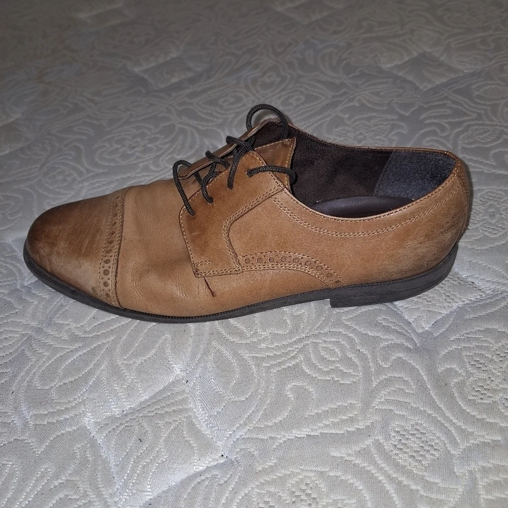 A pair of Cole Haan Oxfords in a men's size 12M. Pre-loved in good condition.